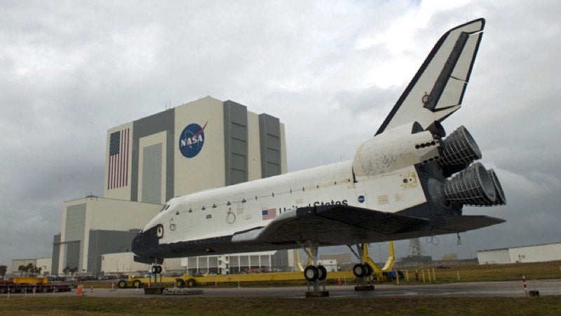 Space shuttle in front of NASA building